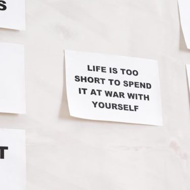 Motivational quotes on white paper promoting healthy habits and lifestyle changes.